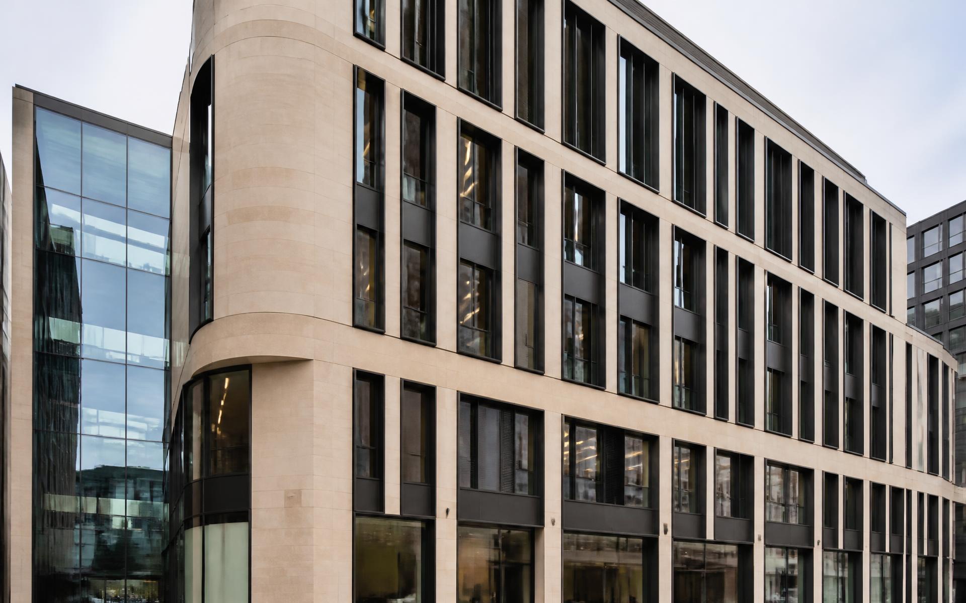 Stone and bronze-framed façade of a contemporary British commercial building